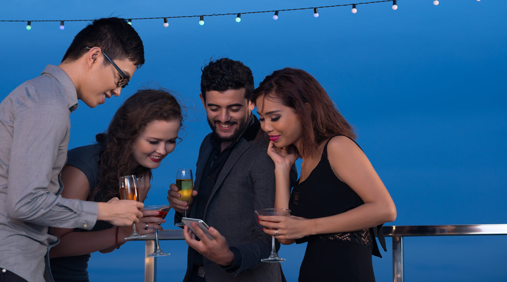guests at a party looking at cell phone