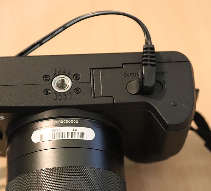 Photo of Canon EOS M50 showing power cable attached to base of camera